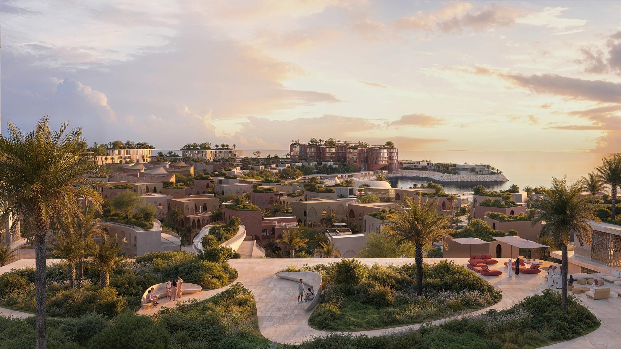 Villa clusters at Mira Coral Bay above the water, lit at dusk