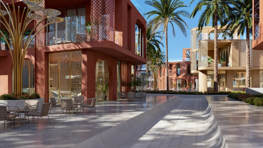 Restaurant terraces along a shaded walkway within the community